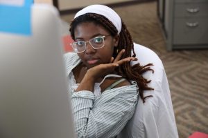 Madeleine Kiluba works on an assignment at her computer in the Xposure newsroom.